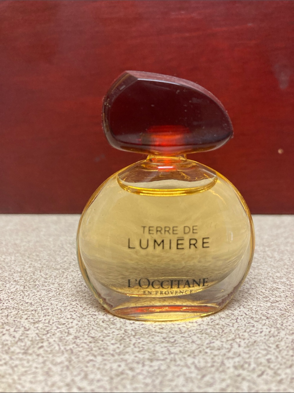 L'OCCITANE Terre de Lumière Mini Bottle - Amber Gold with Dark Red Cap